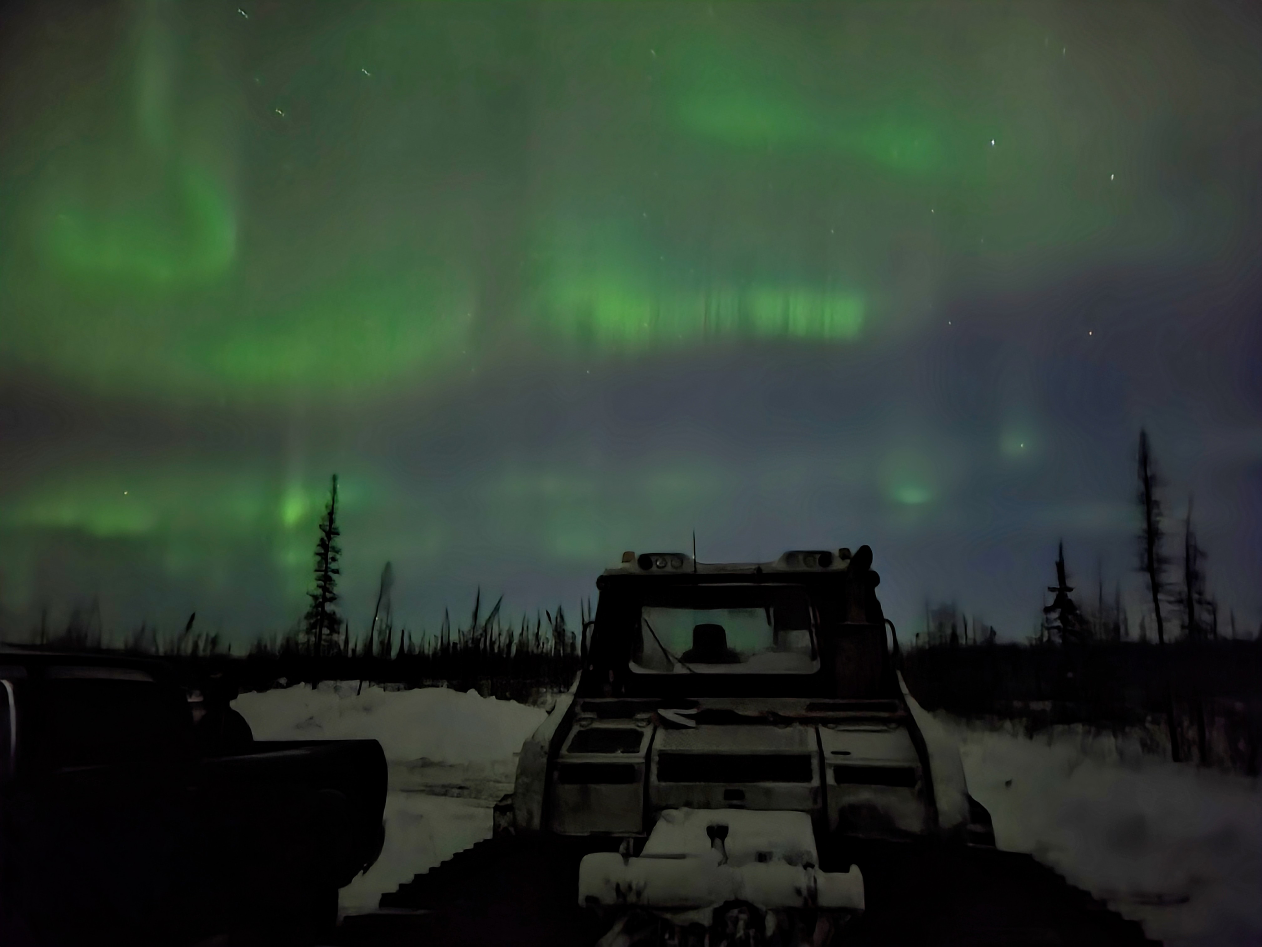 Winter road employee Jamie Gustafson captured this incredible photo of our Snowcat under the dancing northern lights.