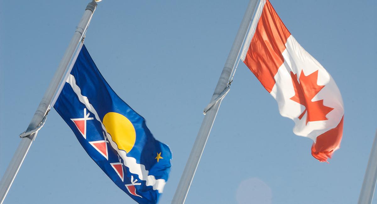Canadian and Tlicho Flag in the wind