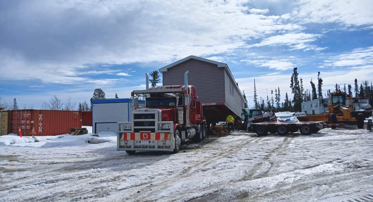 Photo of truck dropping off trailer for TPM's Housing Initiative 